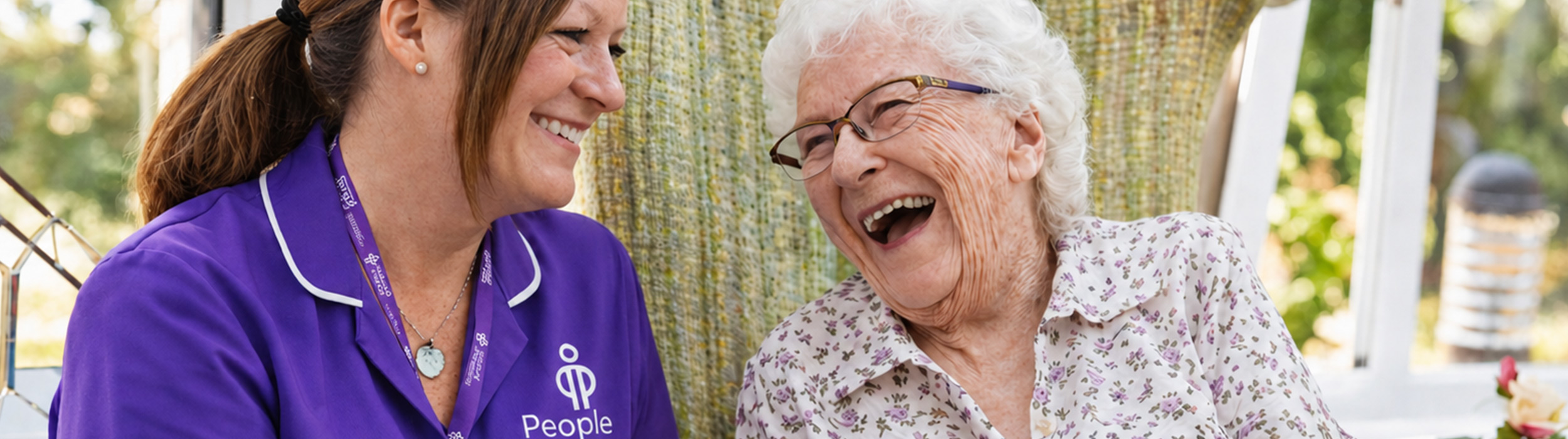 Carer laughing with old lady